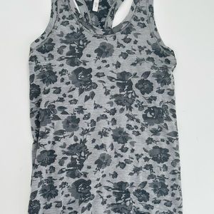 Popular Athleta Activewear Top. Size Small. Well made Grey and black floral.